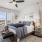 a bedroom with a bed and windows