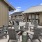 a patio with chairs tables and fireplace
